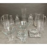 A selection of glass decanters, cut glass ashtrays and dishes, various makers