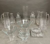 A selection of glass decanters, cut glass ashtrays and dishes, various makers