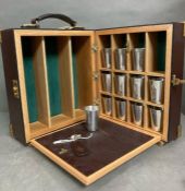 Leather and brass banded drinks companion/field bar, opening to shot cups and four bottle holders