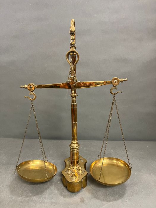 A set of brass weigh scales with integral weights to base