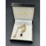 A 9ct gold ruby pendant on a 9ct fine chain