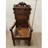 A carved oak Welsh wainscot or Bardic chair (H133cm W60cm D54cm)