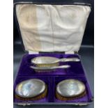 A dressing table set of four silver backed brushes with crest by Levi and Salaman. Hallmarked for