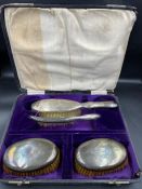 A dressing table set of four silver backed brushes with crest by Levi and Salaman. Hallmarked for