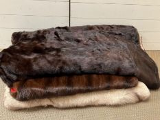 A selection of three various fur throws