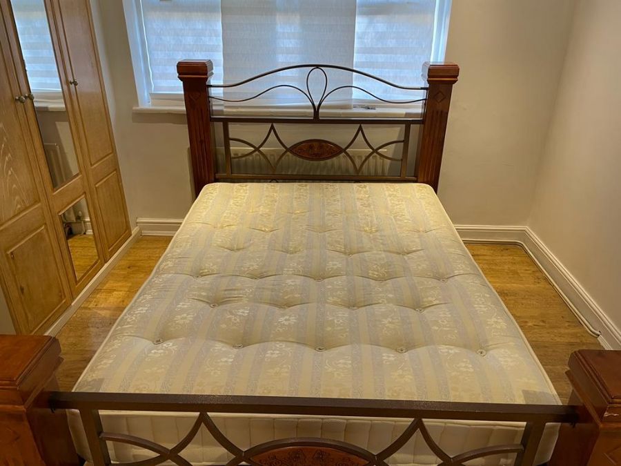 A light mahogany bed frame