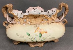 A china centre piece with scrolling handles and floral decoration to front