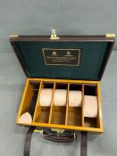 A leather and brass banded carriage case, Holland and Holland with green felt lining