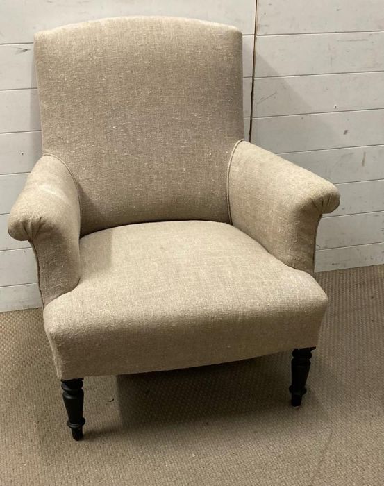 An antique French armchair on turned legs