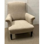 An antique French armchair on turned legs