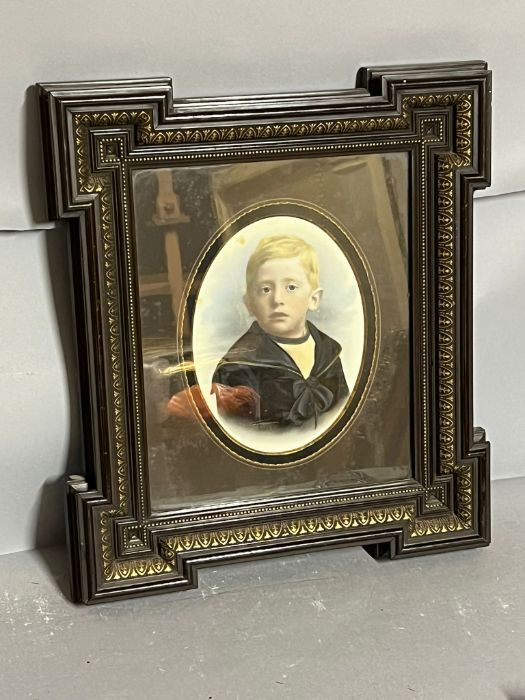 A portrait of a young boy in a sailor uniform, in an ebony style and gilt frame 38cm x 43cm