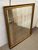A gilt framed foxed mirror 88cm x 104cm