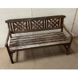 A wooden garden bench with three cross panelled back