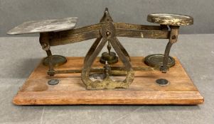 A set of oak and brass postal scales