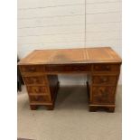 A pedestal desk with leather top (H73cm W124cm D60cm)