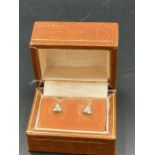 A Pair of three stone diamond earrings in a triangular shape