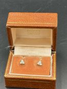 A Pair of three stone diamond earrings in a triangular shape