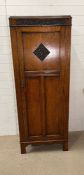 A single oak hall cupboard, panelled front opening to hanging hooks and mirror (H180cm W70cm D38cm)