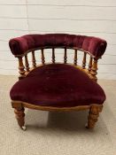 A Victorian tub chair with claret velvet upholstery and spindle back