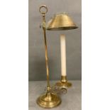 A brass candle stick with brass shade