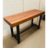 A wooden plank table with steel legs by Marina Home (H94cm W167cm D56cm)