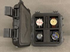 A selection of four Vostok designer watches in a Vostok case