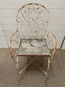 A painted metal scrolling garden chair