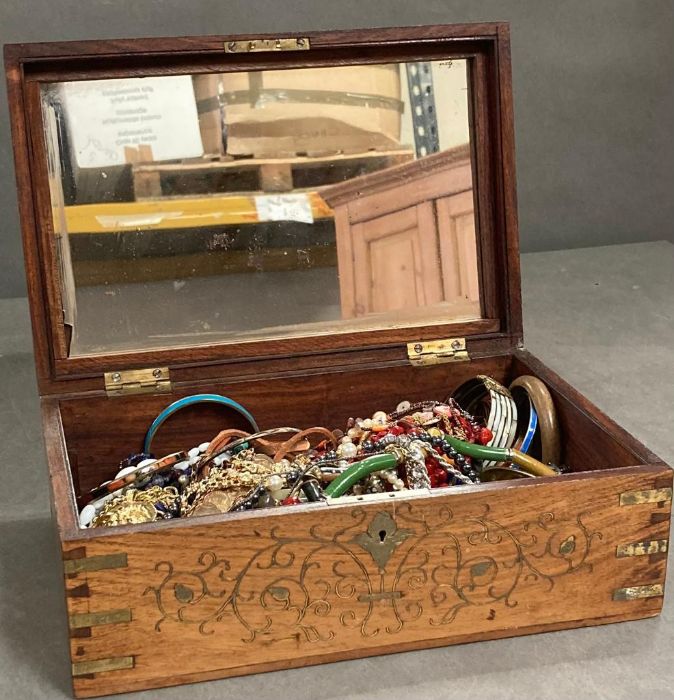 A large selection of costume jewellery in an inlaid jewellery box