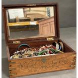 A large selection of costume jewellery in an inlaid jewellery box
