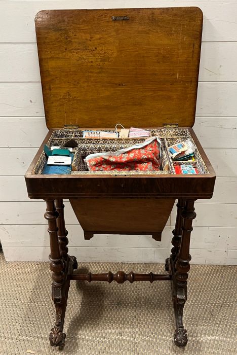 A walnut and mahogany work table, opening up to sewing compartments (H74cm W54cm D39cm)