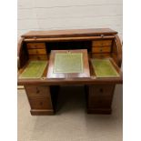 An English mahogany and leather cylinder roll top desk by Moore London, Tambour front with sliding/