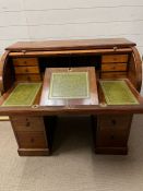 An English mahogany and leather cylinder roll top desk by Moore London, Tambour front with sliding/