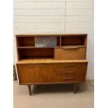 A teak Mid Century sideboard on tapering legs (H127cm W137cm D41cm)