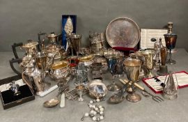 A Large volume of silver plated items to include tea services, tray, cutlery etc.