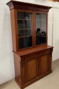 A mahogany glazed bookcase with cupboard under (H215cm W120cm D48cm)