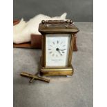 A small brass carriage clock by Thwaites and Reed in original box (H8.5cm)