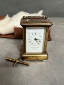 A small brass carriage clock by Thwaites and Reed in original box (H8.5cm)