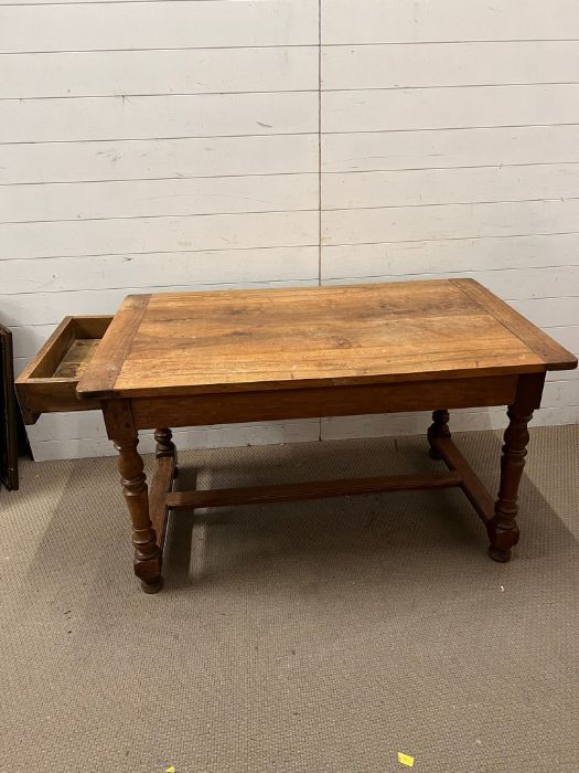 A farmhouse table with drawer to one end on turned legs and centre stretcher (H74cm W130cm D78cm) - Image 3 of 3