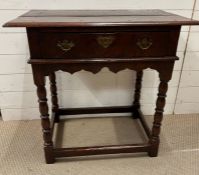 An oak 18th Century single drawer side table with brass handles on turned legs