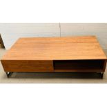 A rectangular low coffee table on chrome legs (H32cm W140cm D80cm)