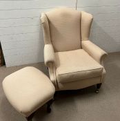 A wing back chair with mahogany turned legs and brass castors along with a matching foot stool