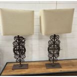 A pair of metal scrolling table lamps with square shades
