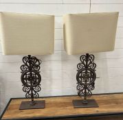 A pair of metal scrolling table lamps with square shades