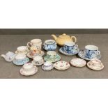 A large selection of miniature tea cups and saucers, various makers and ages