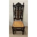 An oak carved back side chair with cane seat