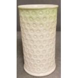 A small Belleek white and green vase