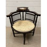 A corner chair with inlaid back and spindle sides on turned legs and out scrolling arms