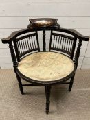A corner chair with inlaid back and spindle sides on turned legs and out scrolling arms