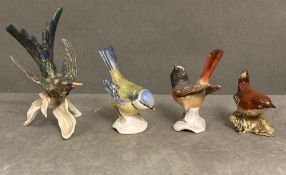 A selection of three W Goebel china birds and one by Beswick.