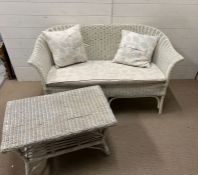 A wicker two seater sofa and coffee table (H77cm W137cm D65cm)